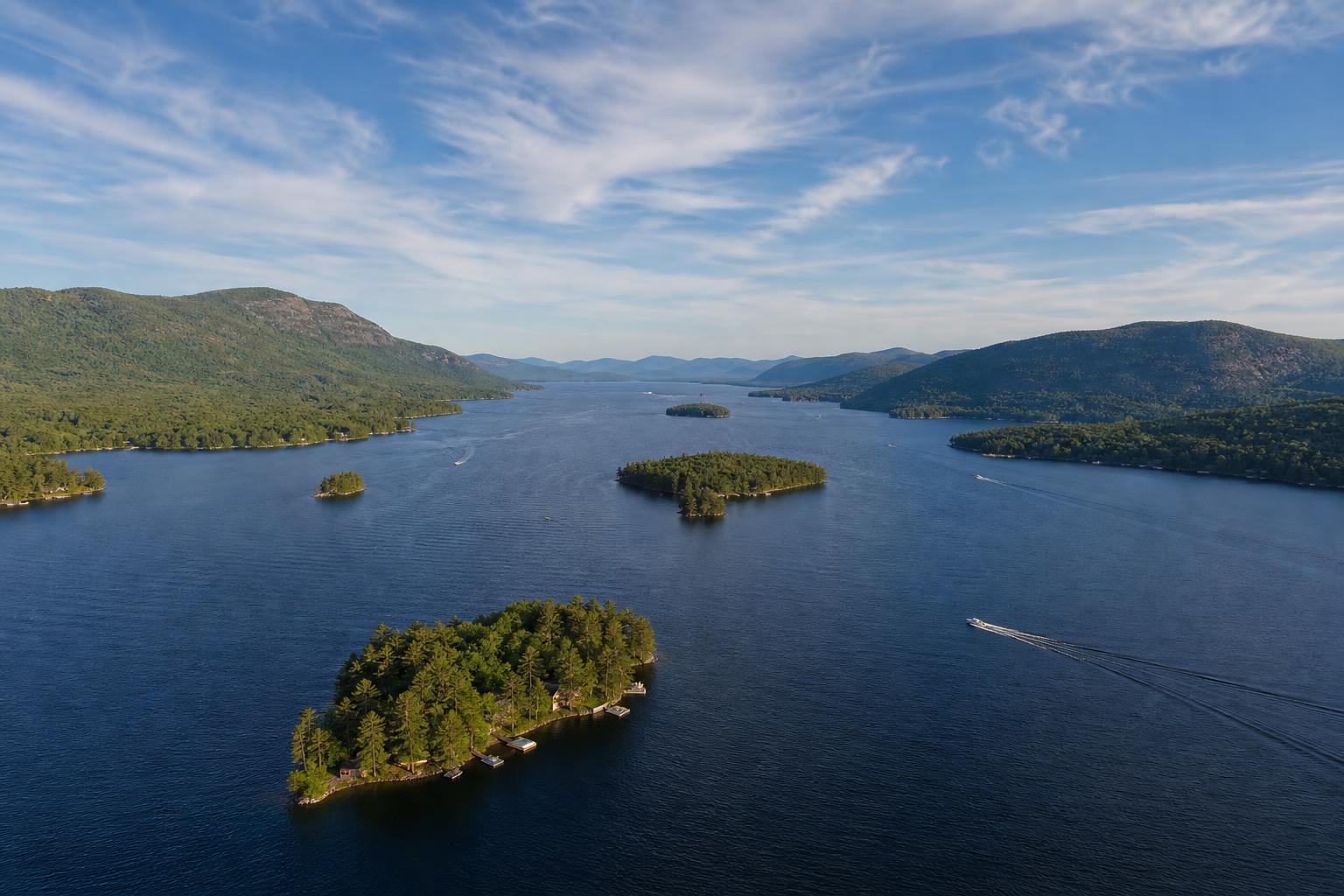 Aerial view of Lake George with lakefront estate and Adirondack mountains